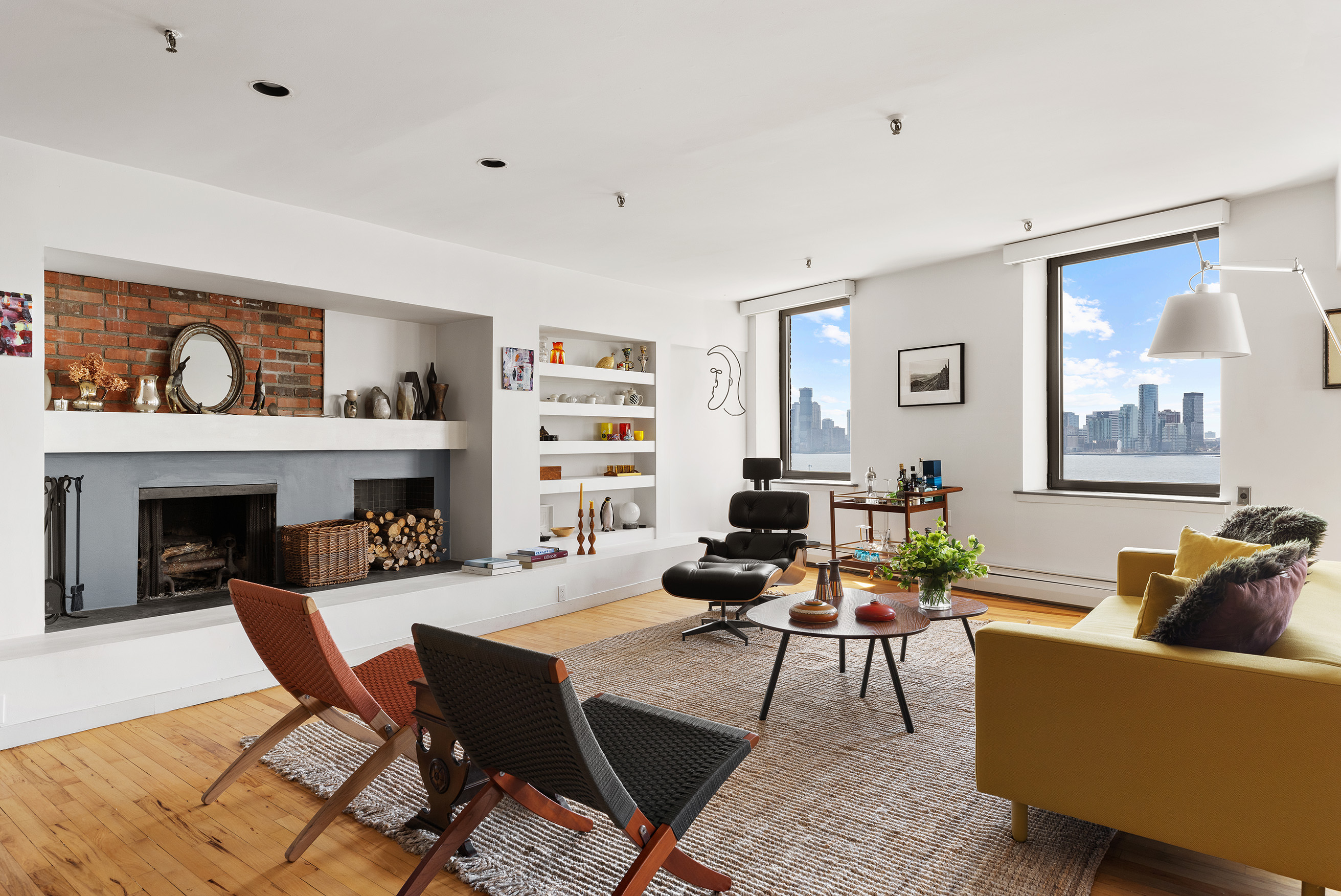 166 Bank Street, Unit 6B Manhattan, NY 10014 - Photo 2 of 16 a living room with furniture and a fireplace