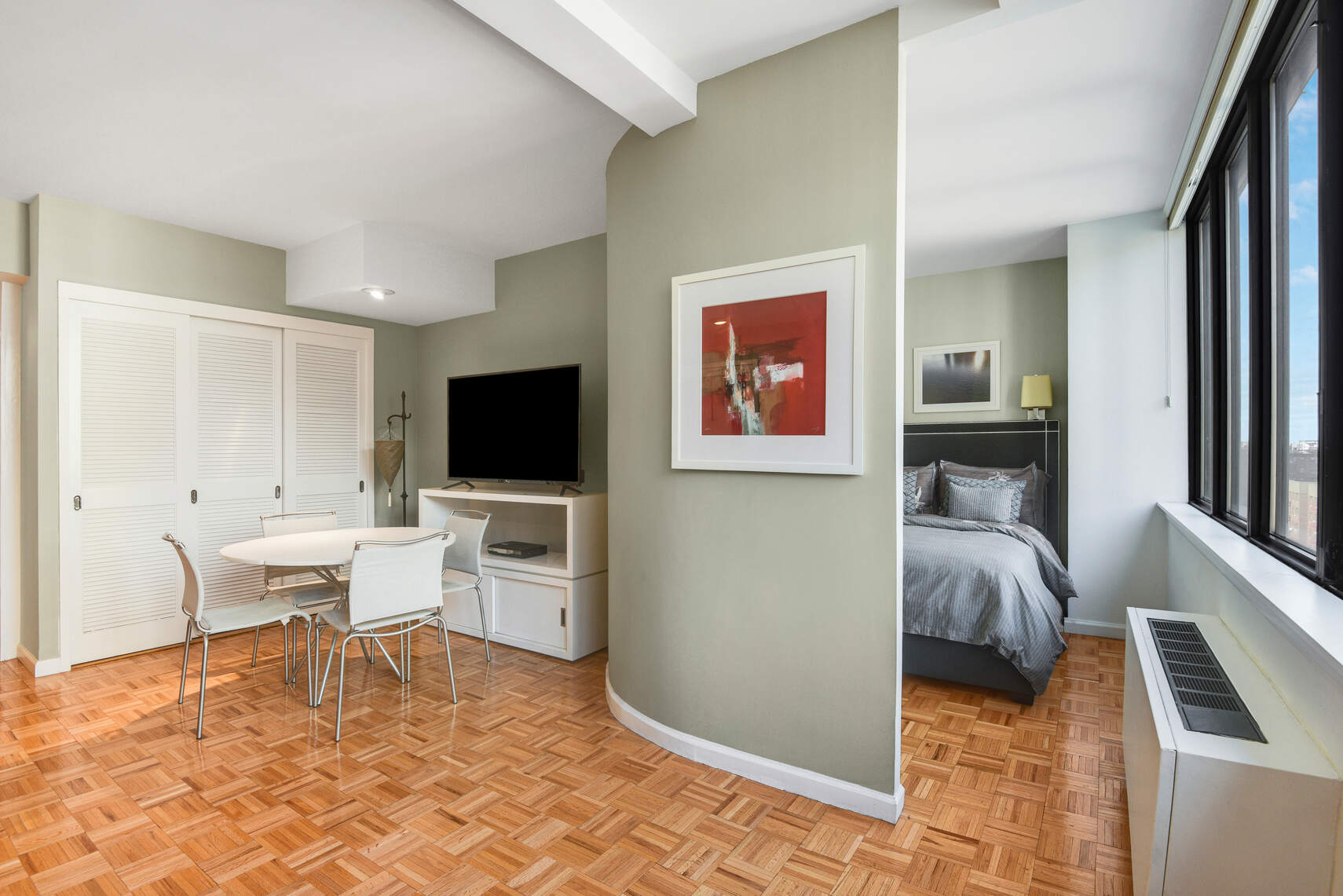 455 East 86th Street, Unit 8D Manhattan, NY 10028 - Photo 5 of 13 a living room with furniture and a flat screen tv