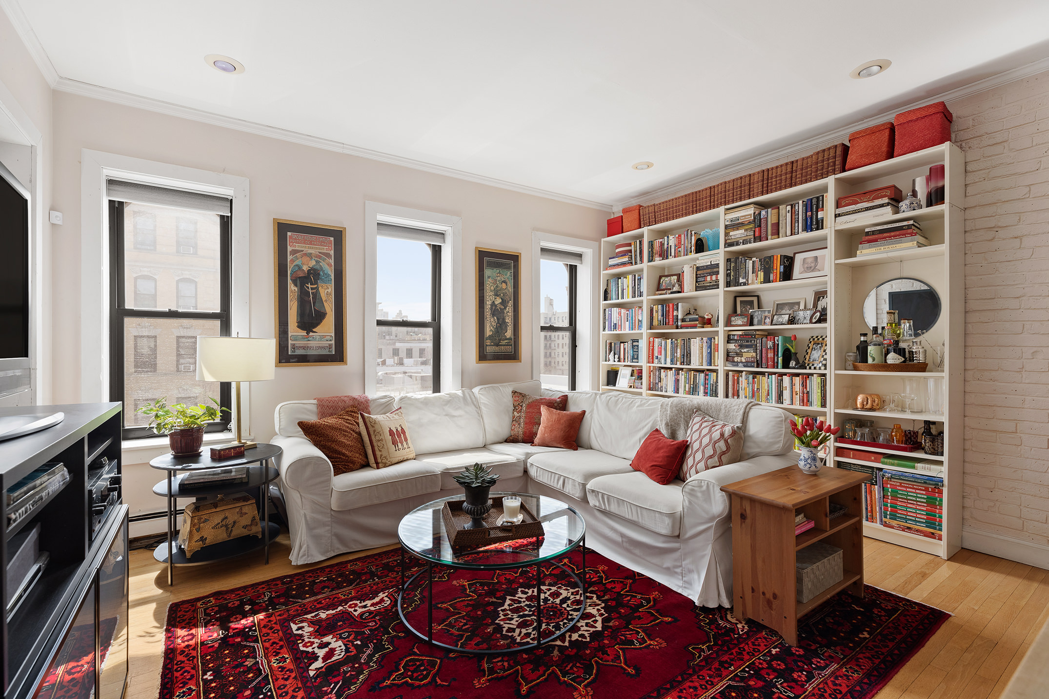 657 West 183rd Street Manhattan, NY 10033 - Photo 13 of 22 a living room with furniture and a bookshelf