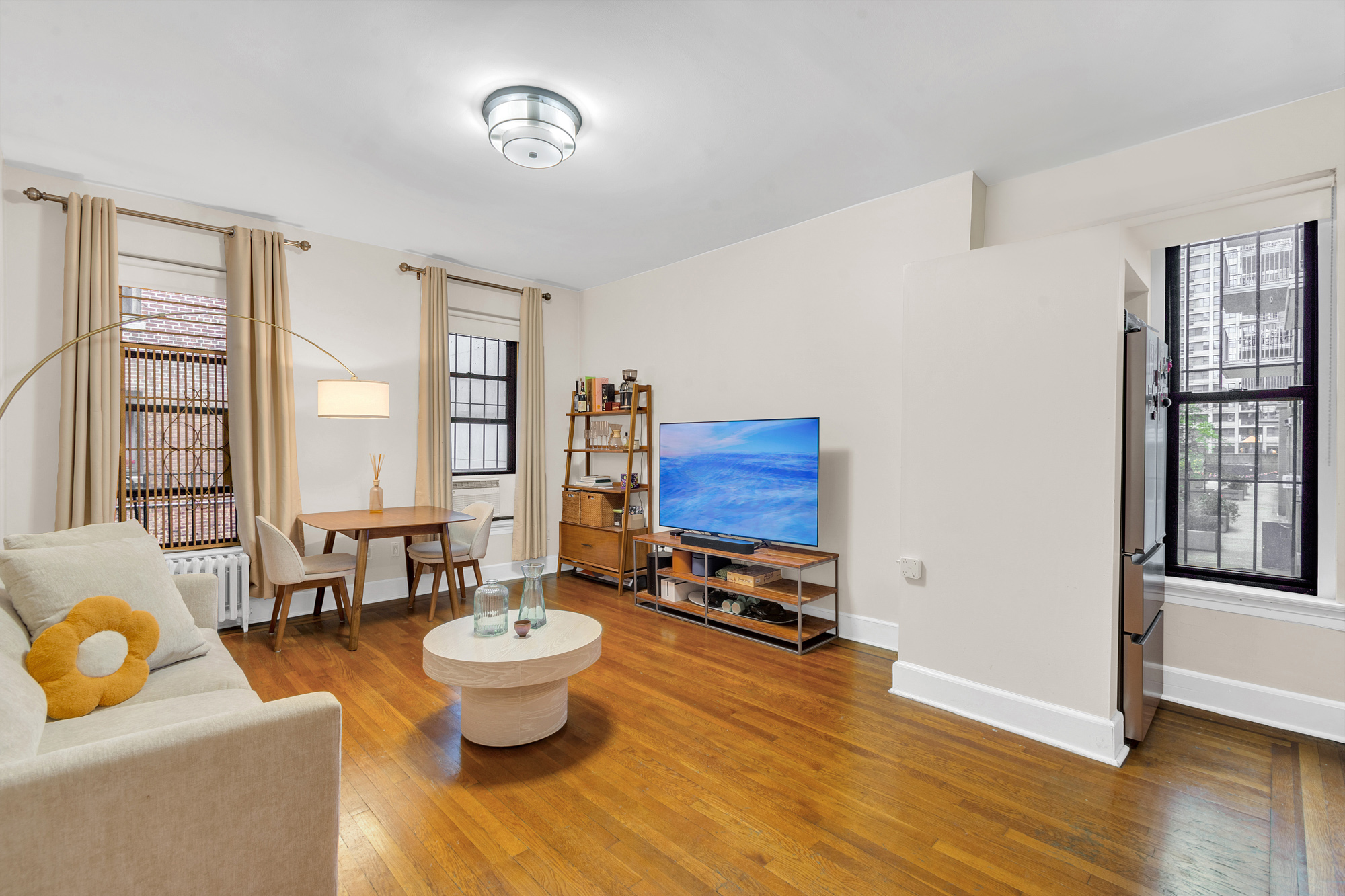 26 West 97th Street, Unit 2C Manhattan, NY 10025 - Photo 2 of 9 a living room with furniture and a large window