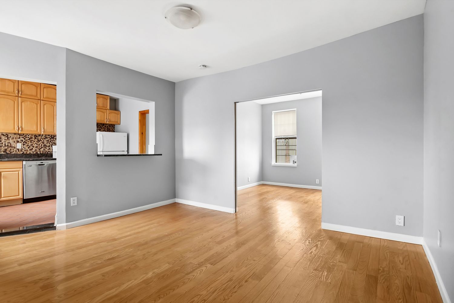 133 17th Street, Unit 4R Brooklyn, NY 11215 - Photo 2 of 7 a view of an empty room with wooden floor and a window