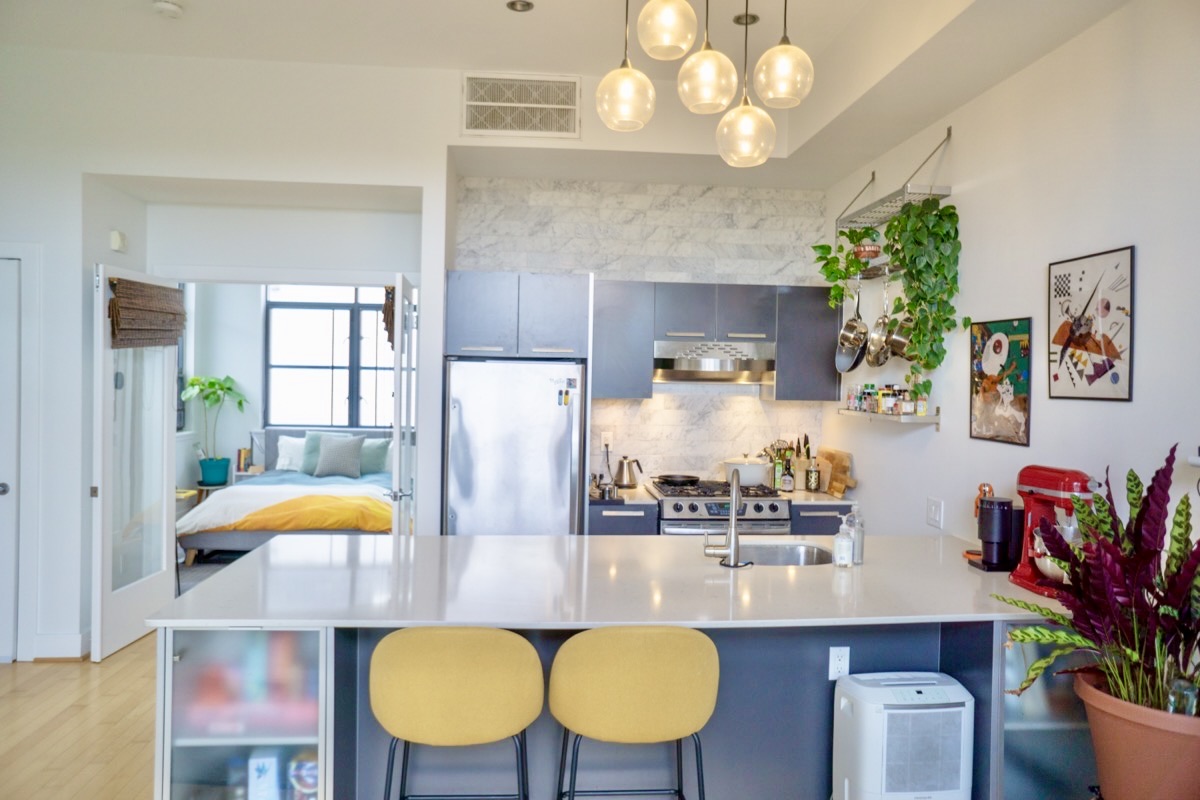 2426 Ontario Road Northwest, Unit 401 Washington, DC 20009 - Photo 3 of 28 a kitchen with stainless steel appliances a table and chairs in it