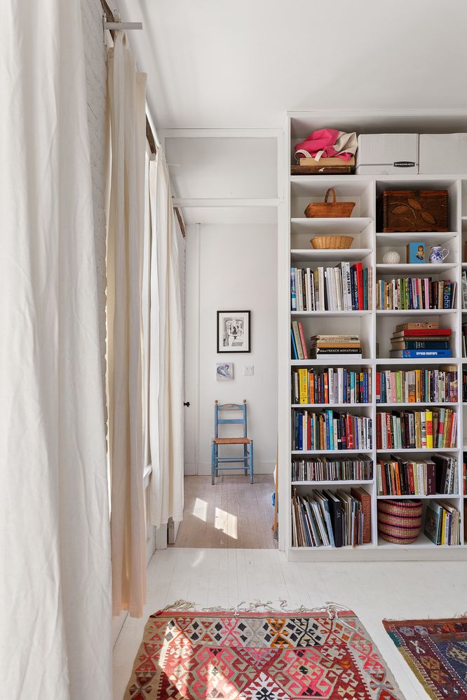 a bedroom with furniture and a book shelf