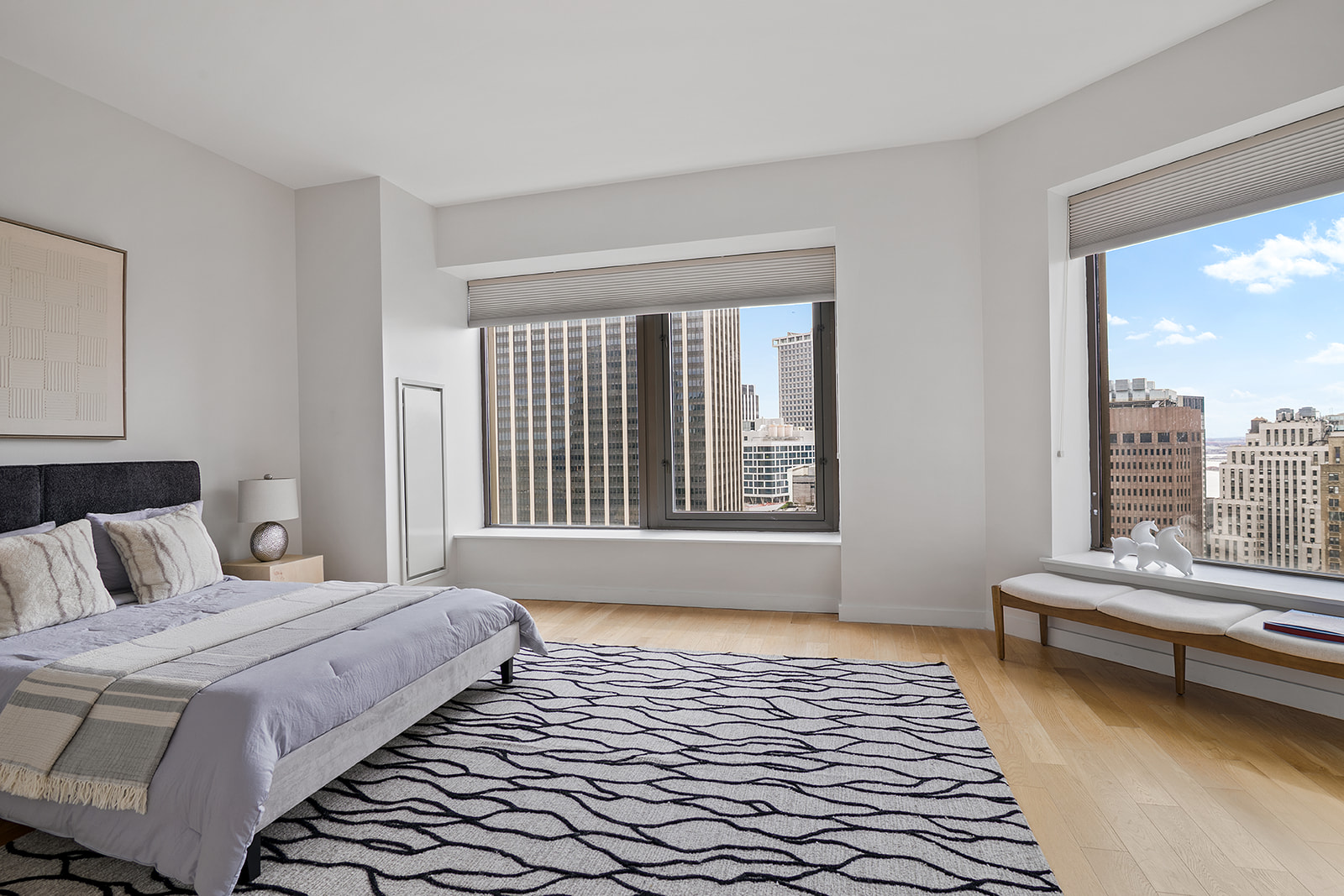 75 Wall Street, Unit 36F Manhattan, NY 10005 - Photo 5 of 15 a bedroom with a bed and a large window