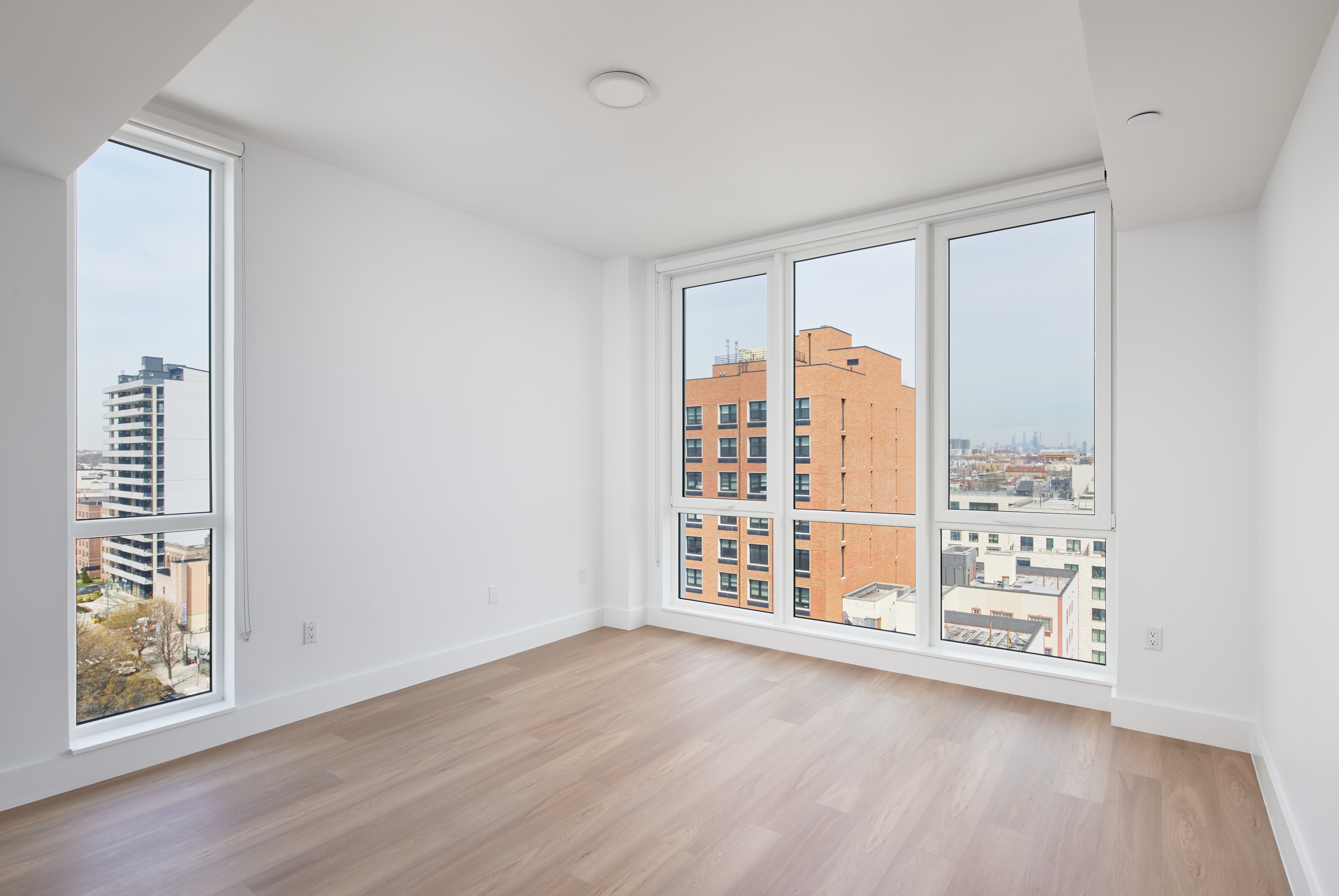 340 Lenox Road, Unit PHB Brooklyn, NY 11226 - Photo 3 of 26 a view of an empty room with a window and wooden floor