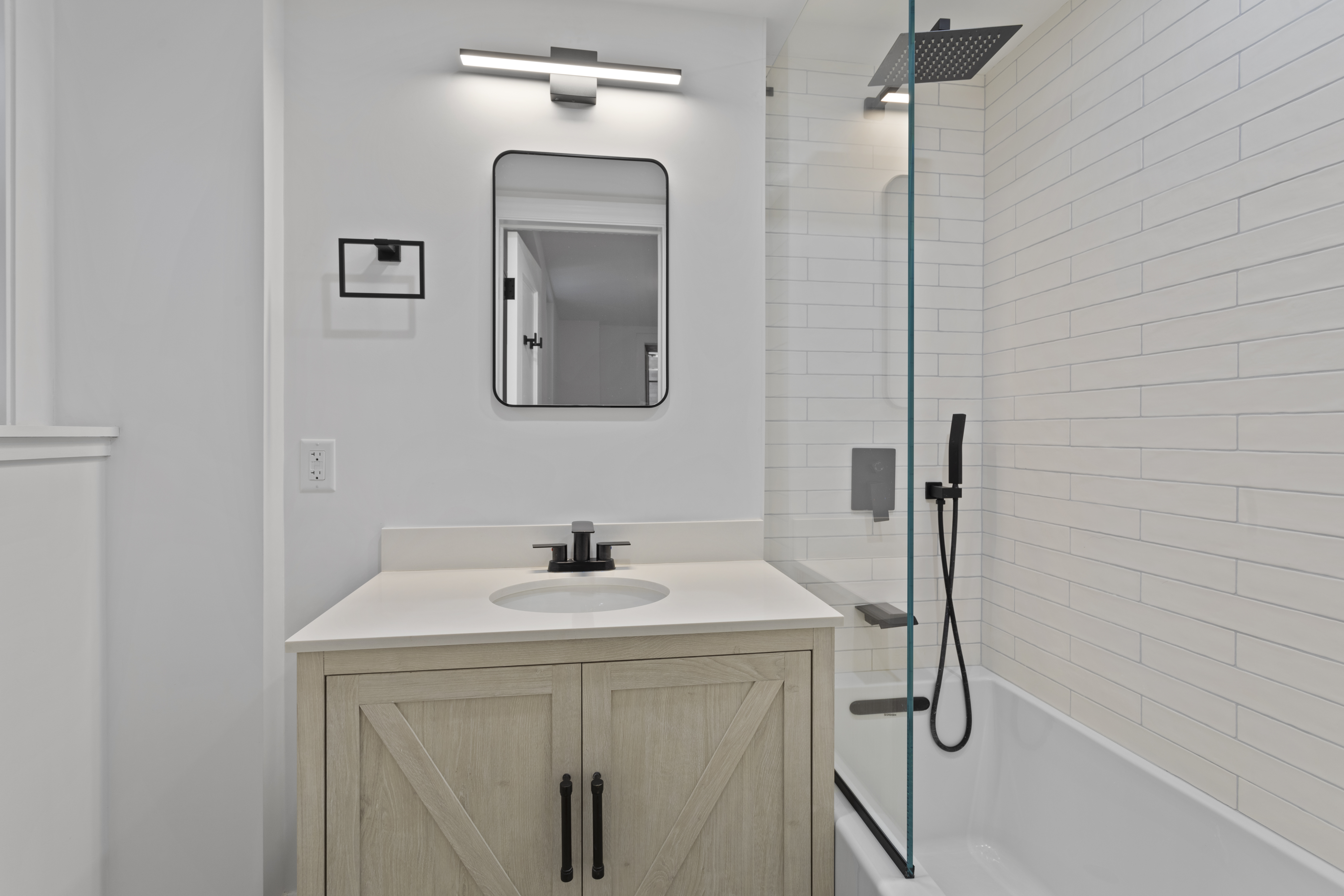 16 Park Avenue, Unit 6CD Manhattan, NY 10016 - Photo 6 of 12 a bathroom with a sink a mirror and vanity