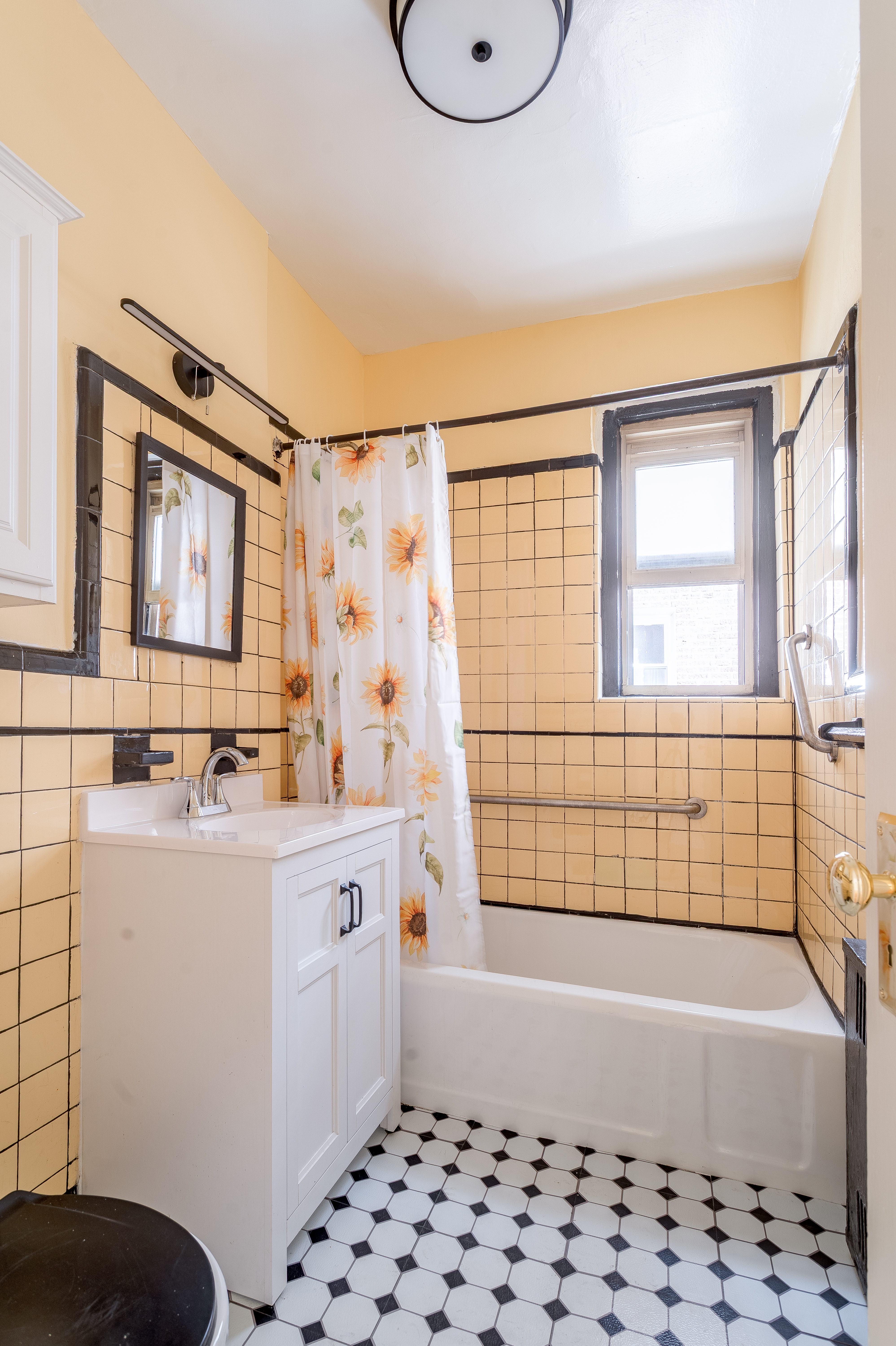 40 Tehama Street, Unit 2E Brooklyn, NY 11218 - Photo 9 of 12 a bathroom with a bathtub sink and mirror