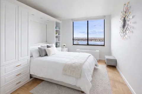 a bedroom with a bed and a window