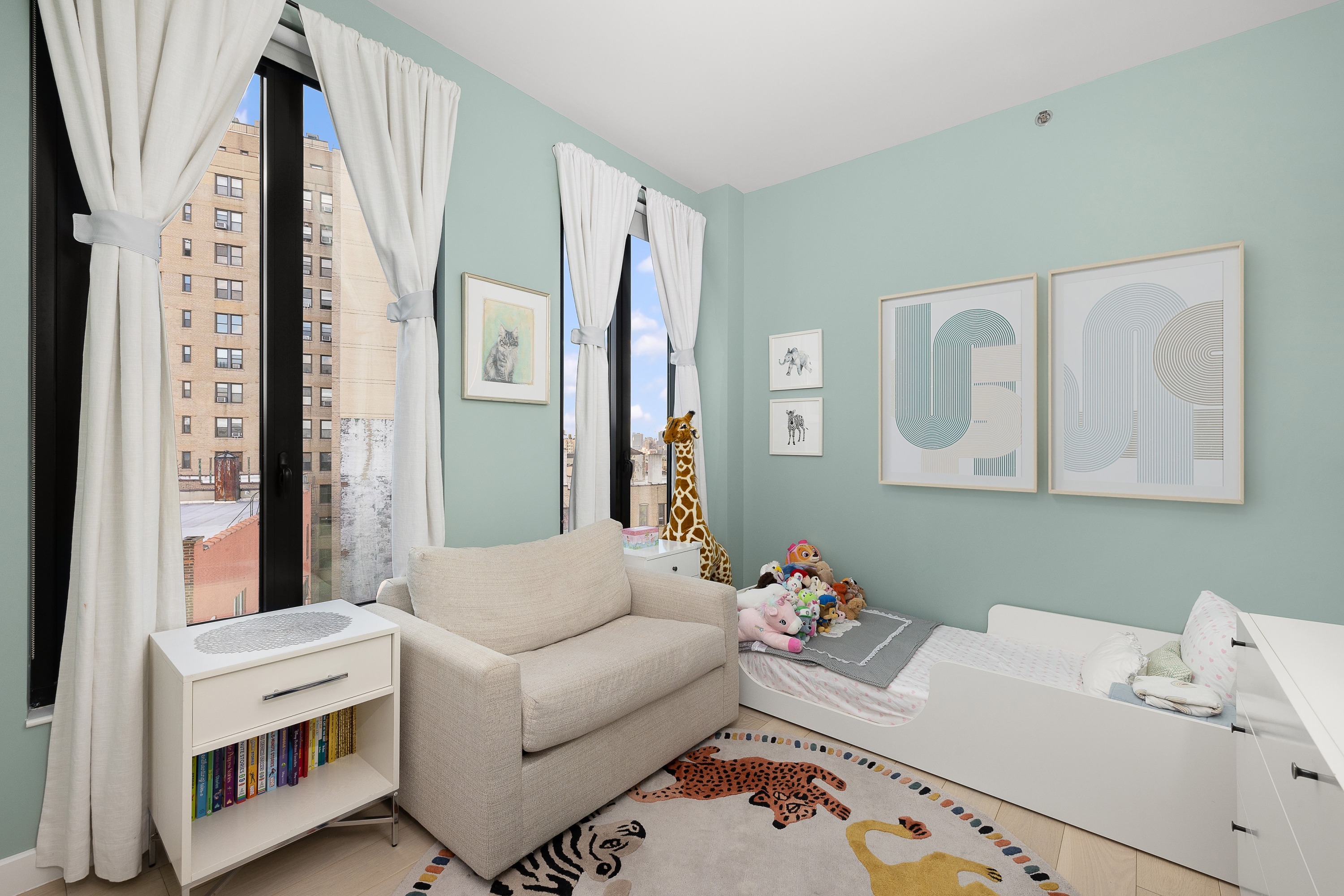 856 Washington Avenue, Unit 9A Brooklyn, NY 11238 - Photo 13 of 25 a living room with furniture and a baby crib