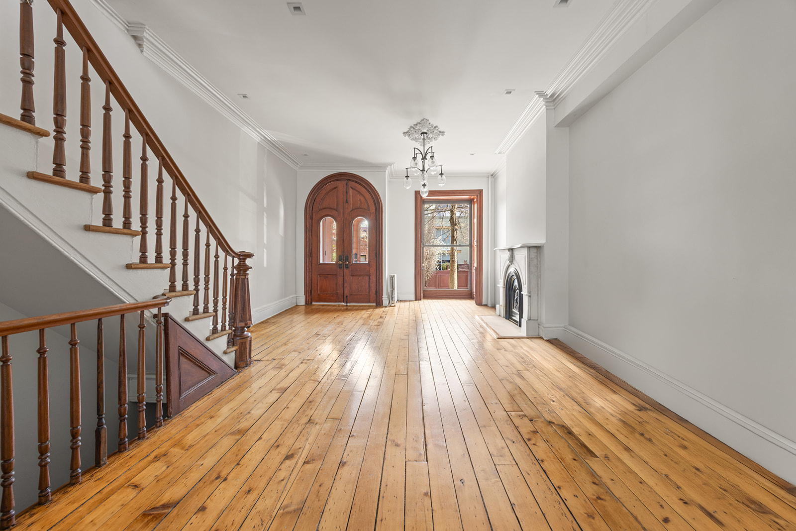 a view of entryway and hall with wooden floor