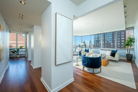 a living room with furniture and a wooden floor