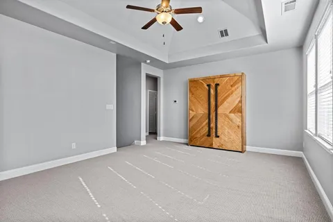 an empty room with windows and closet
