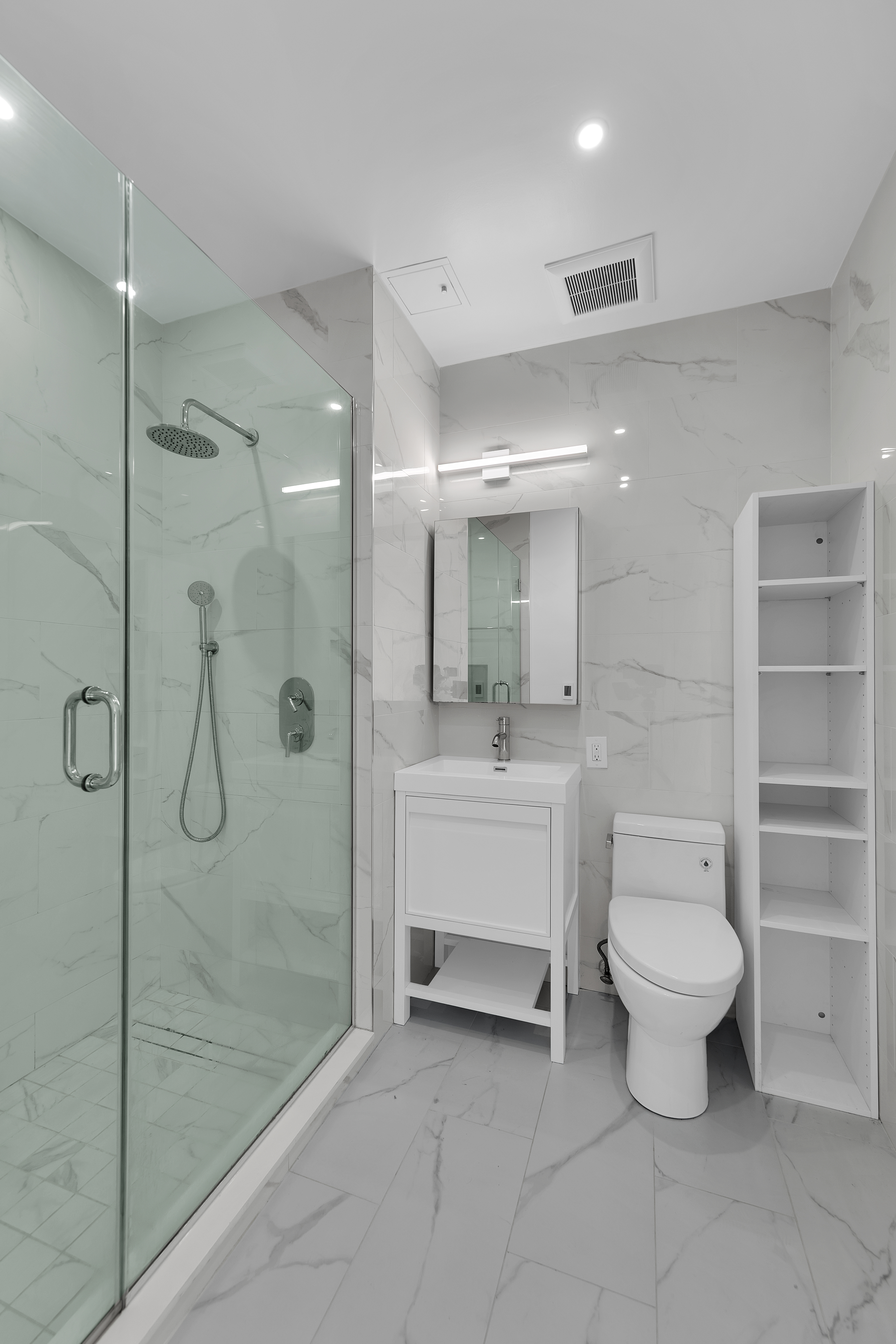 47-01 Vernon Boulevard, Unit 4E Queens, NY 11101 - Photo 7 of 9 a bathroom with a toilet sink and shower