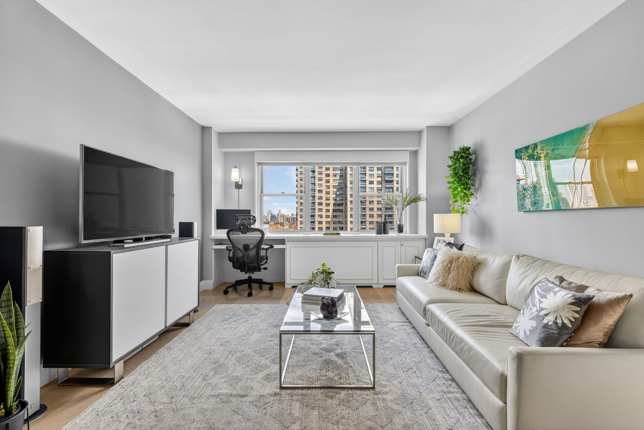 400 East 54th Street, Unit 30D Manhattan, NY 10022 - Photo 2 of 20 a living room with furniture and a flat screen tv