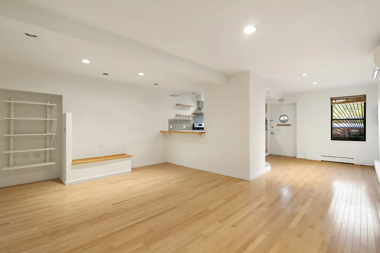 wooden floor in an empty room with a window