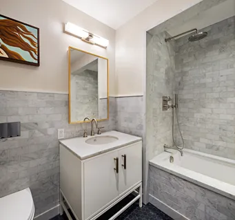 a large white room with a large window and a couch