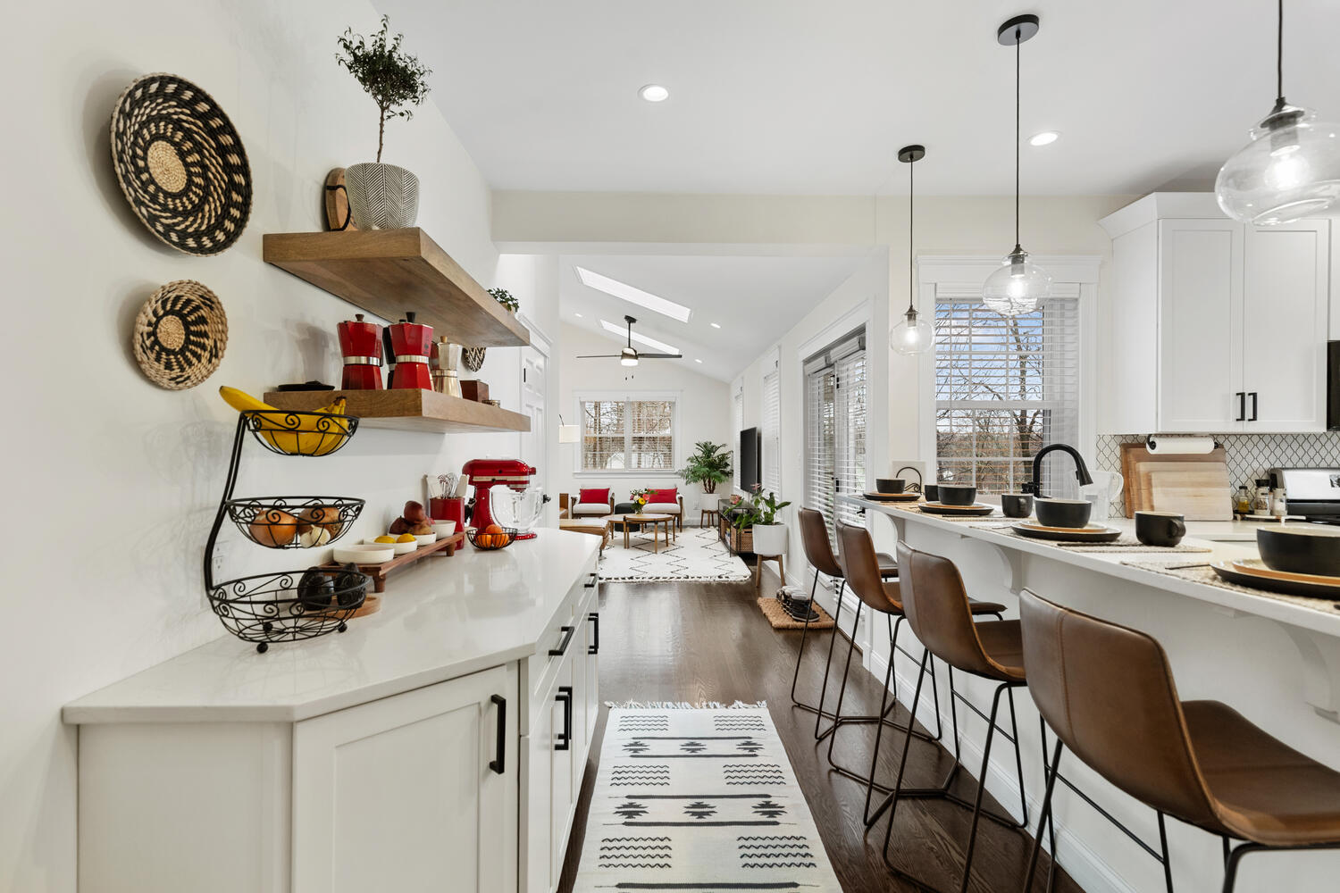 1 Maple Street, Unit 1 Maynard, MA 01754 - Photo 4 of 42 a kitchen with kitchen island granite countertop a stove a sink and a dining table with chairs