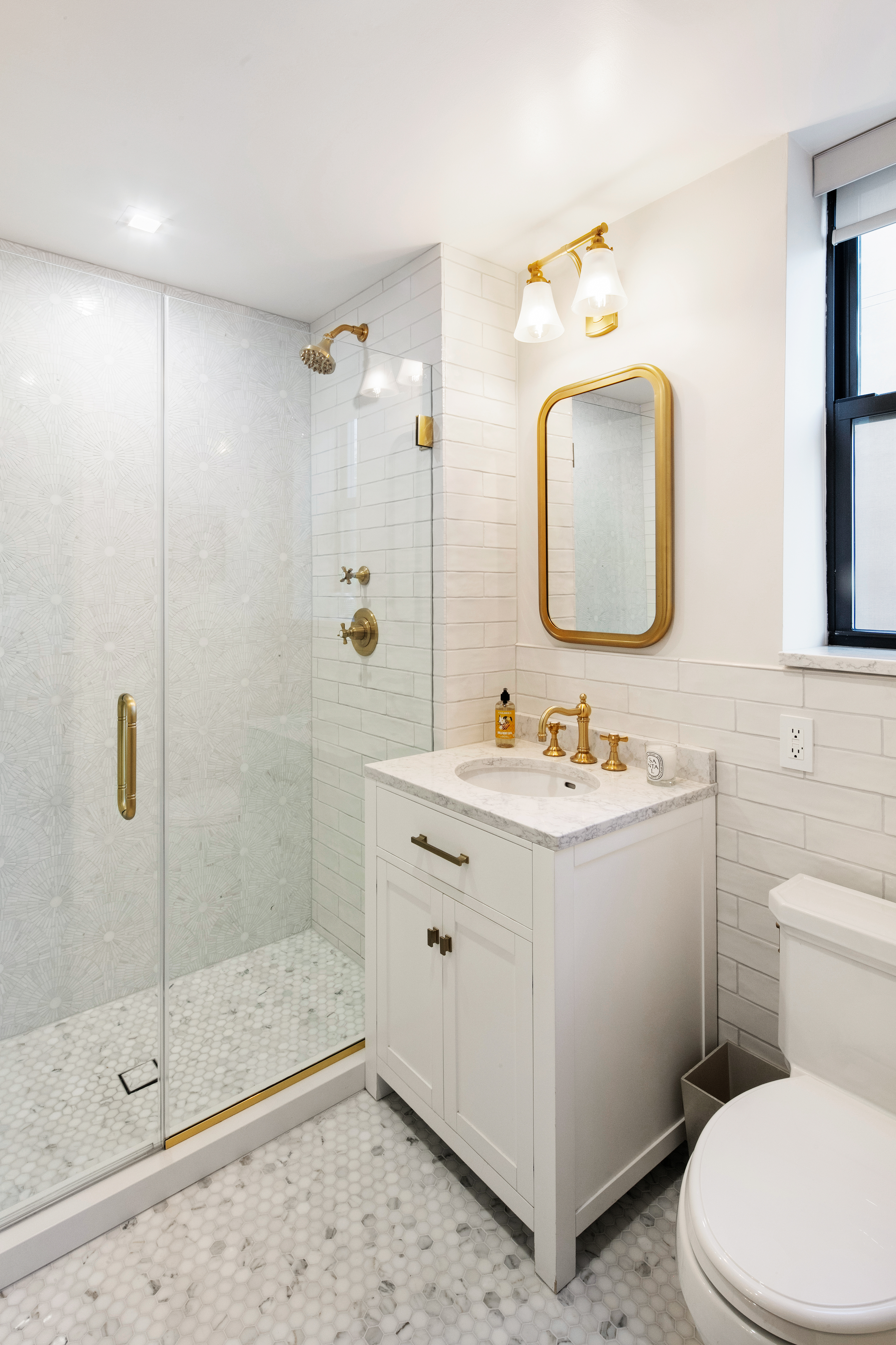 5 West 127th Street, Unit 3B Manhattan, NY 10027 - Photo 7 of 9 a bathroom with a sink mirror vanity and toilet