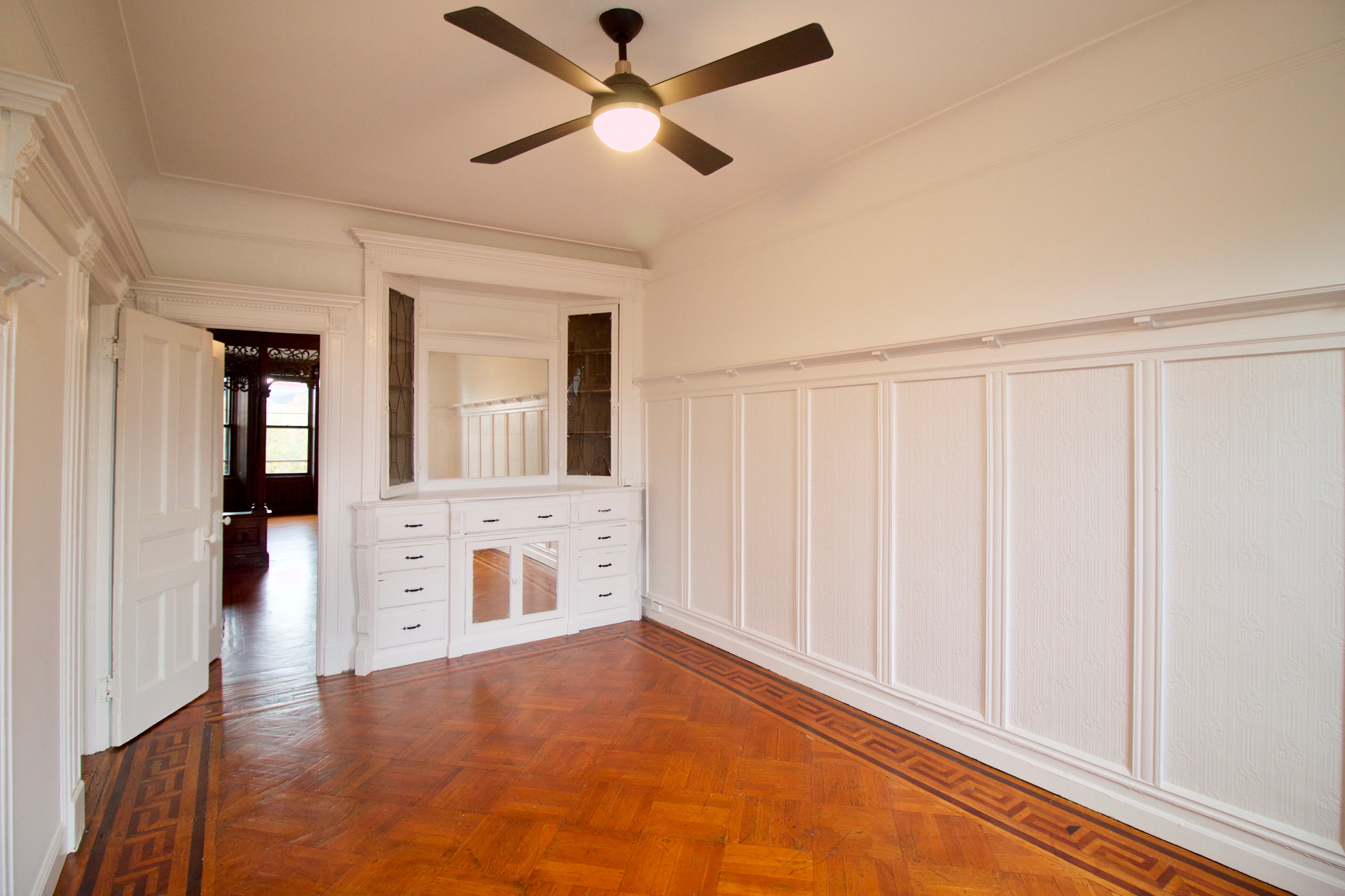 403 Caton Avenue, Unit 3 Brooklyn, NY 11218 - Photo 13 of 31 wooden floor in an empty room with a window