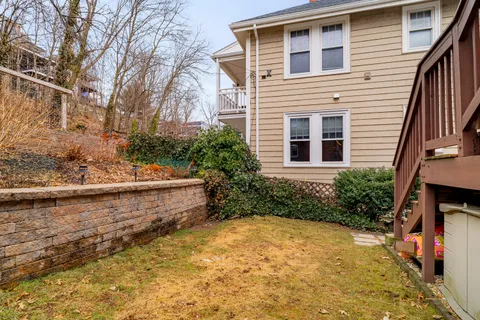 a view of a house with backyard and sitting area
