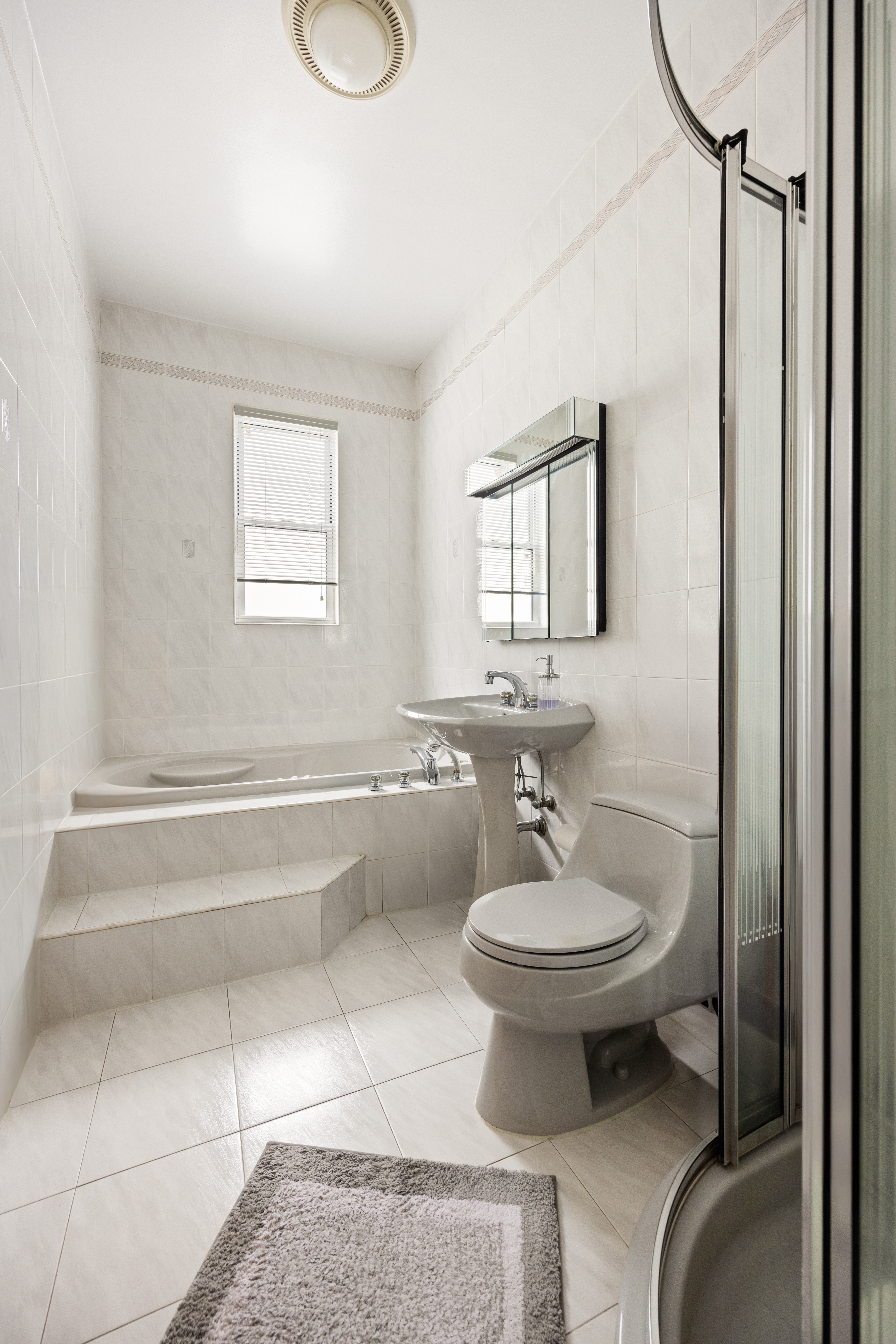 1635 West 12th Street Brooklyn, NY 11223 - Photo 9 of 21 a bathroom with a sink toilet and mirror