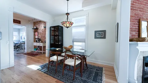 a view of a dining room with furniture wooden floor and chandelier