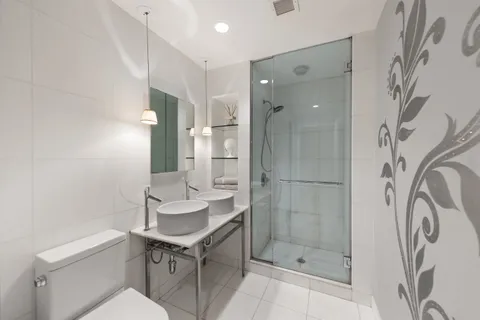 a bathroom with a sink toilet a mirror and shower