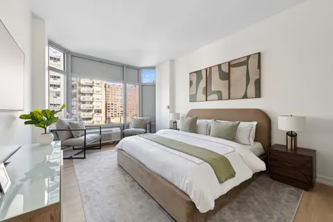 a bedroom with bed and a couch