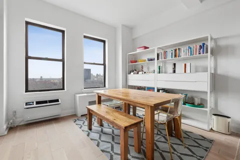 a view of a dining room with furniture and a window