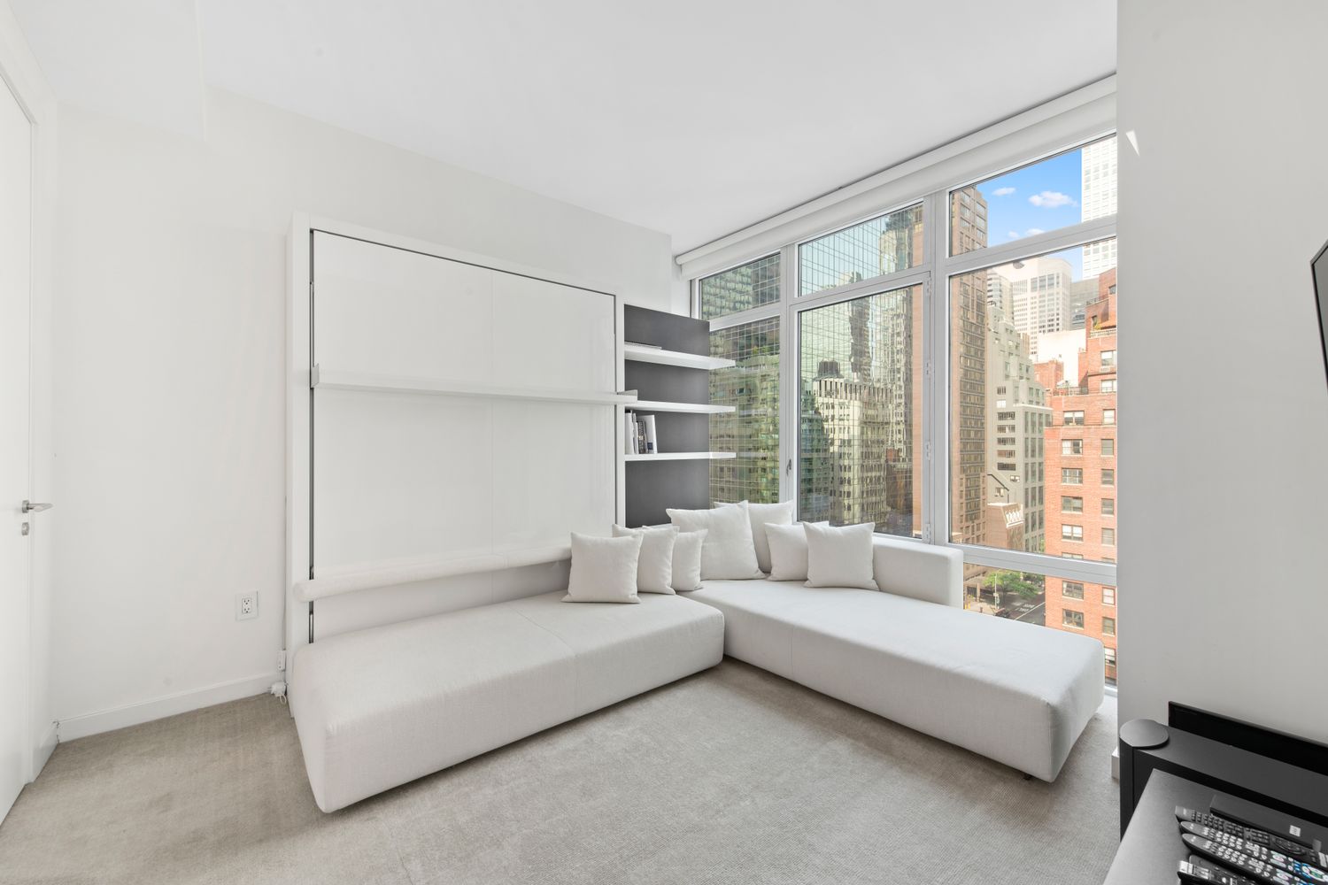 207 East 57th Street, Unit 12A Manhattan, NY 10022 - Photo 8 of 13 a living room with furniture and a large window