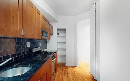 470 West 166th Street, Unit 21 Manhattan, NY 10032 - Photo 2 of 8 a kitchen with a sink and a stove
