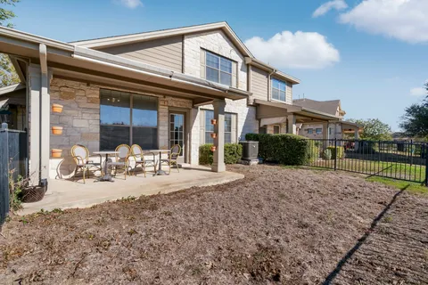 a view of a house with backyard porch and sitting area