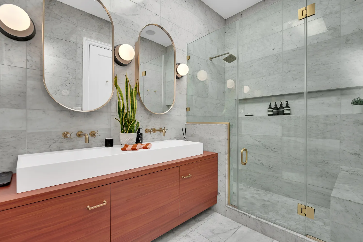 a bathroom with a sink mirror and vanity