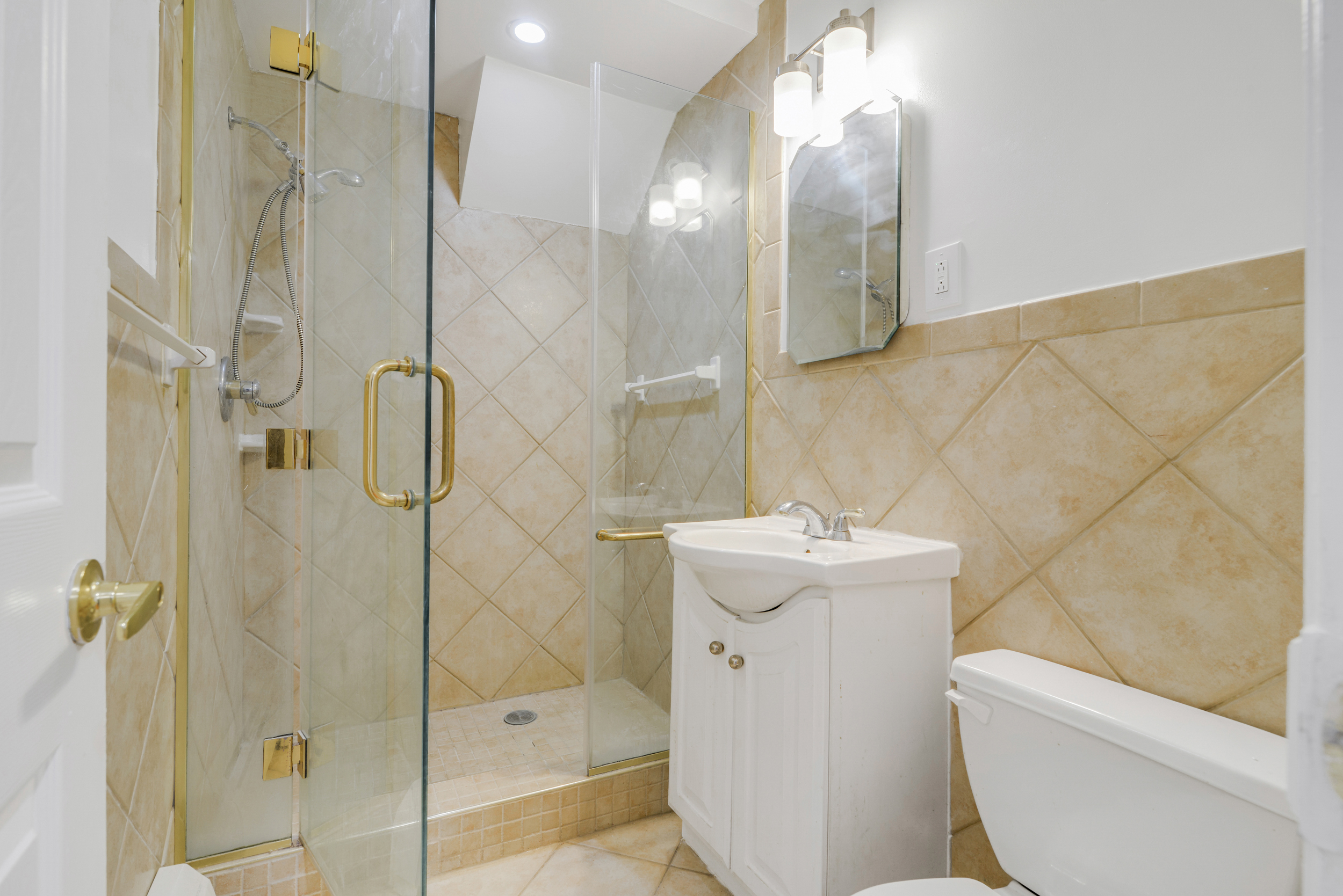3 East 128th Street, Unit GARDEN Manhattan, NY 10035 - Photo 7 of 10 a bathroom with a sink a toilet and shower