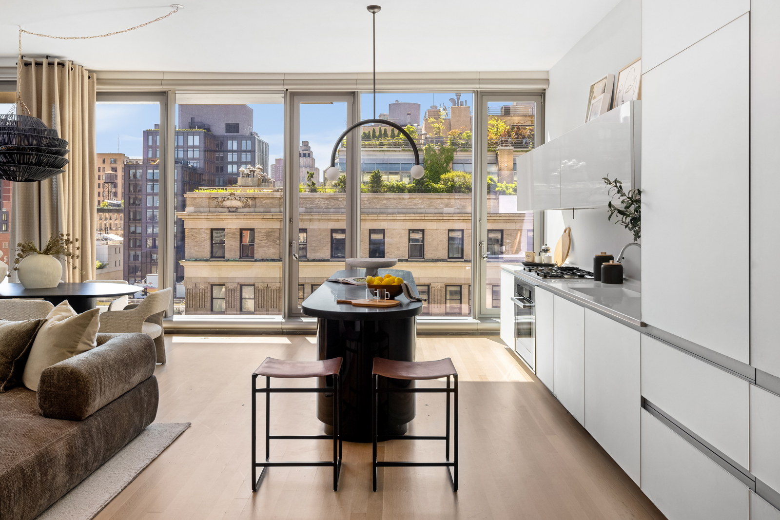 56 Leonard Street, Unit 14BEAST Manhattan, NY 10013 - Photo 5 of 35 a kitchen with stainless steel appliances granite countertop a stove and a refrigerator