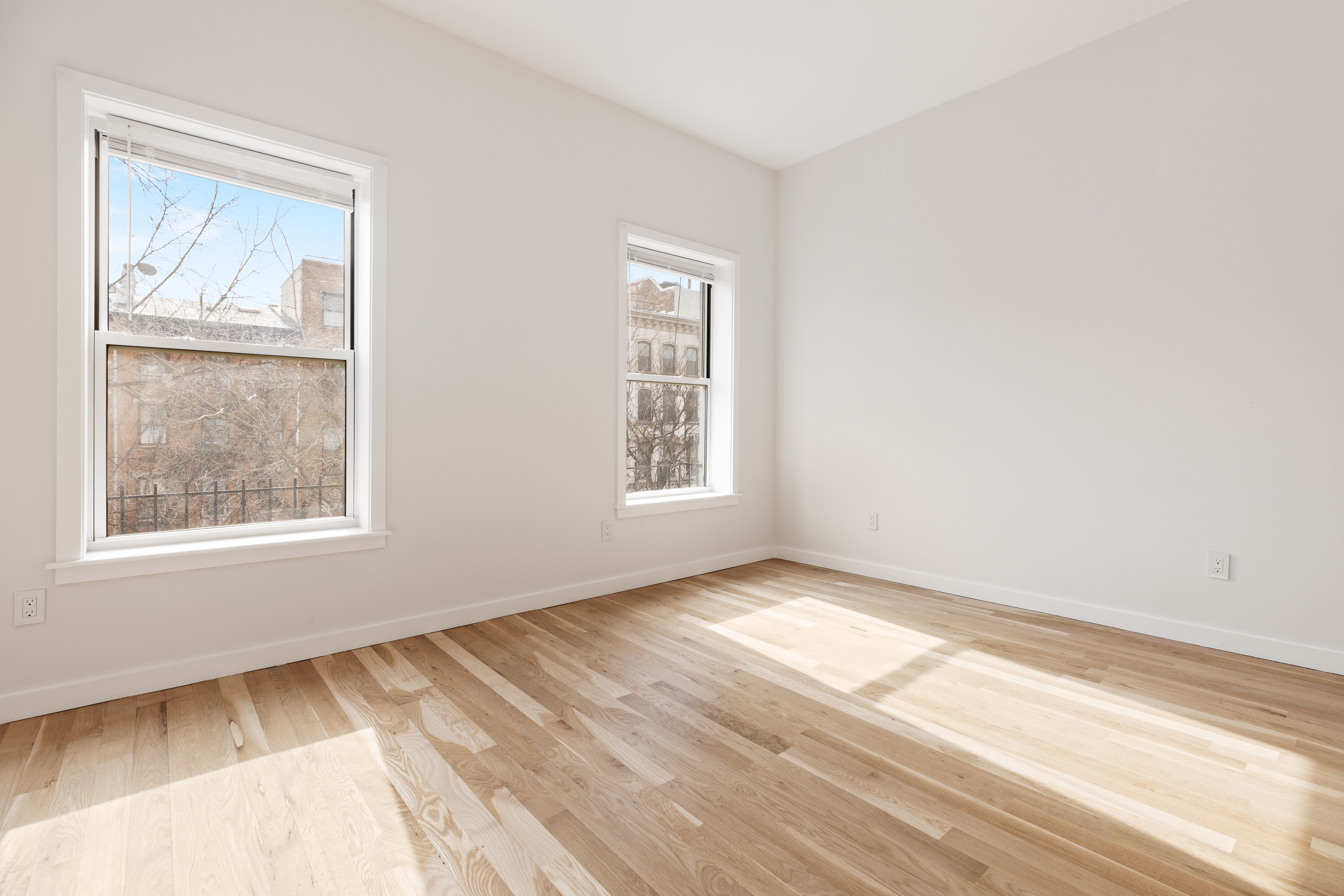 147 Atlantic Avenue, Unit 2 Brooklyn, NY 11201 - Photo 1 of 8 a view of an empty room with wooden floor and a window