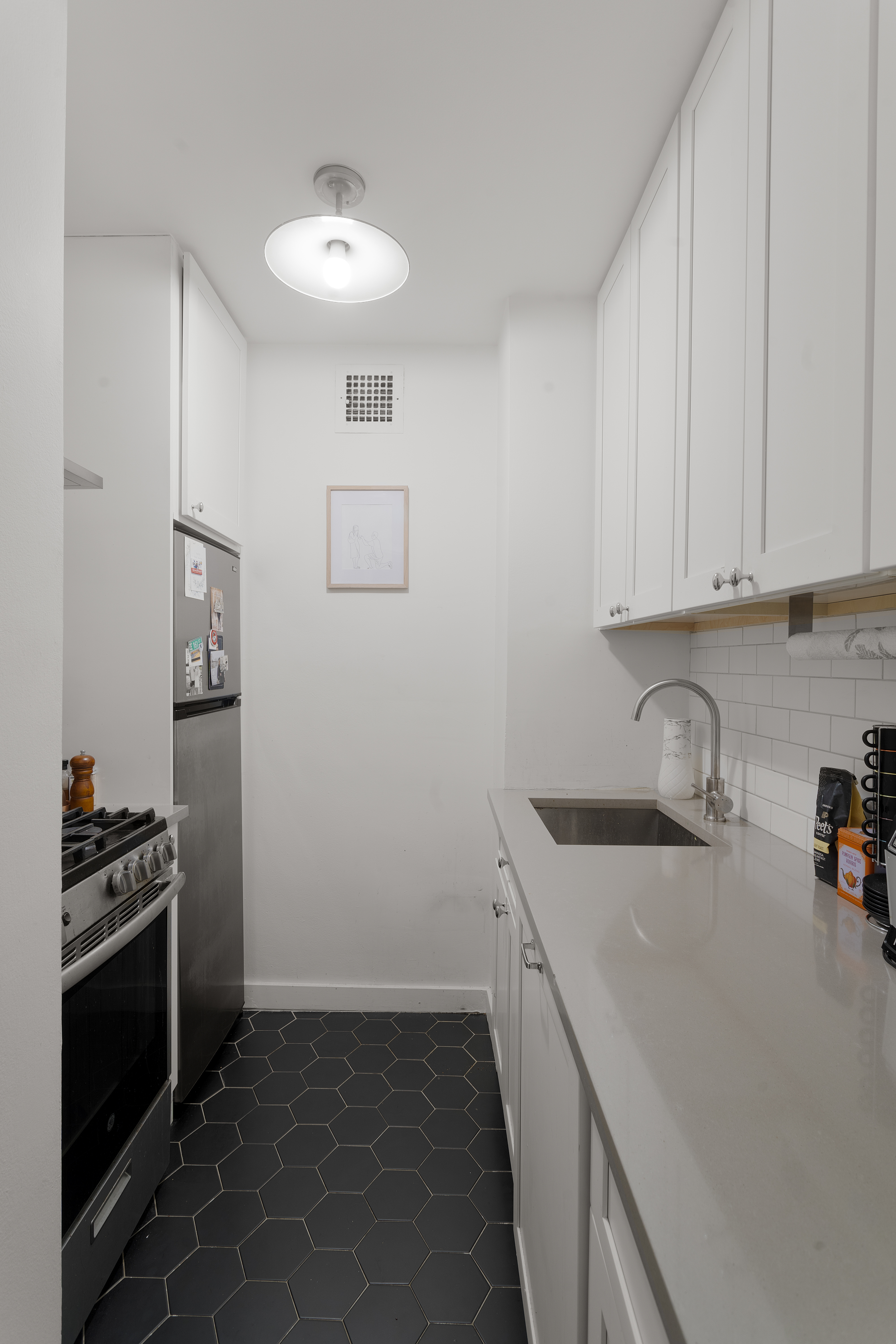 357 East 57th Street, Unit 2E Manhattan, NY 10022 - Photo 5 of 15 a kitchen with a sink and cabinets