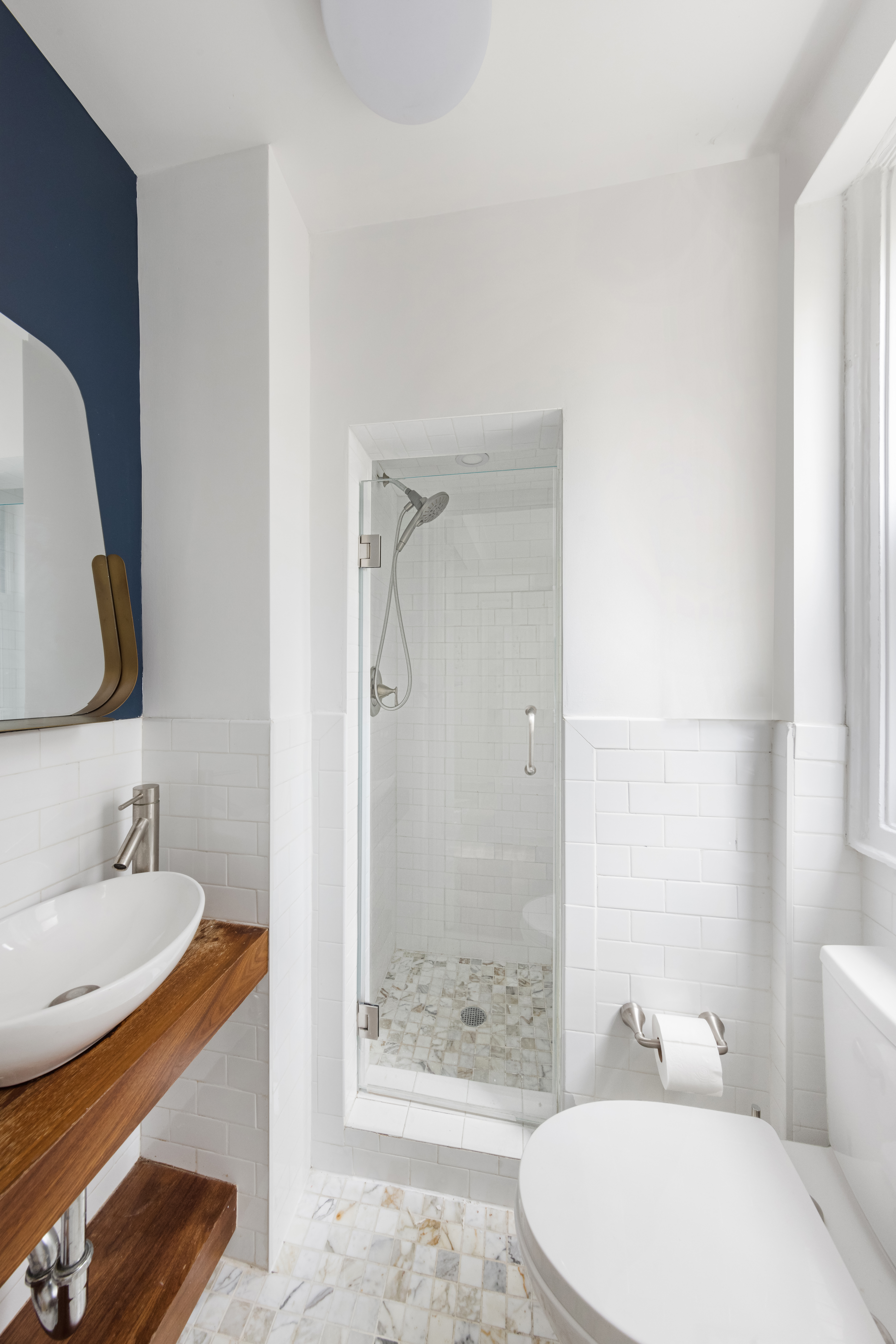 425 East 86th Street, Unit 2F Manhattan, NY 10028 - Photo 8 of 11 a bathroom with a sink a toilet and shower