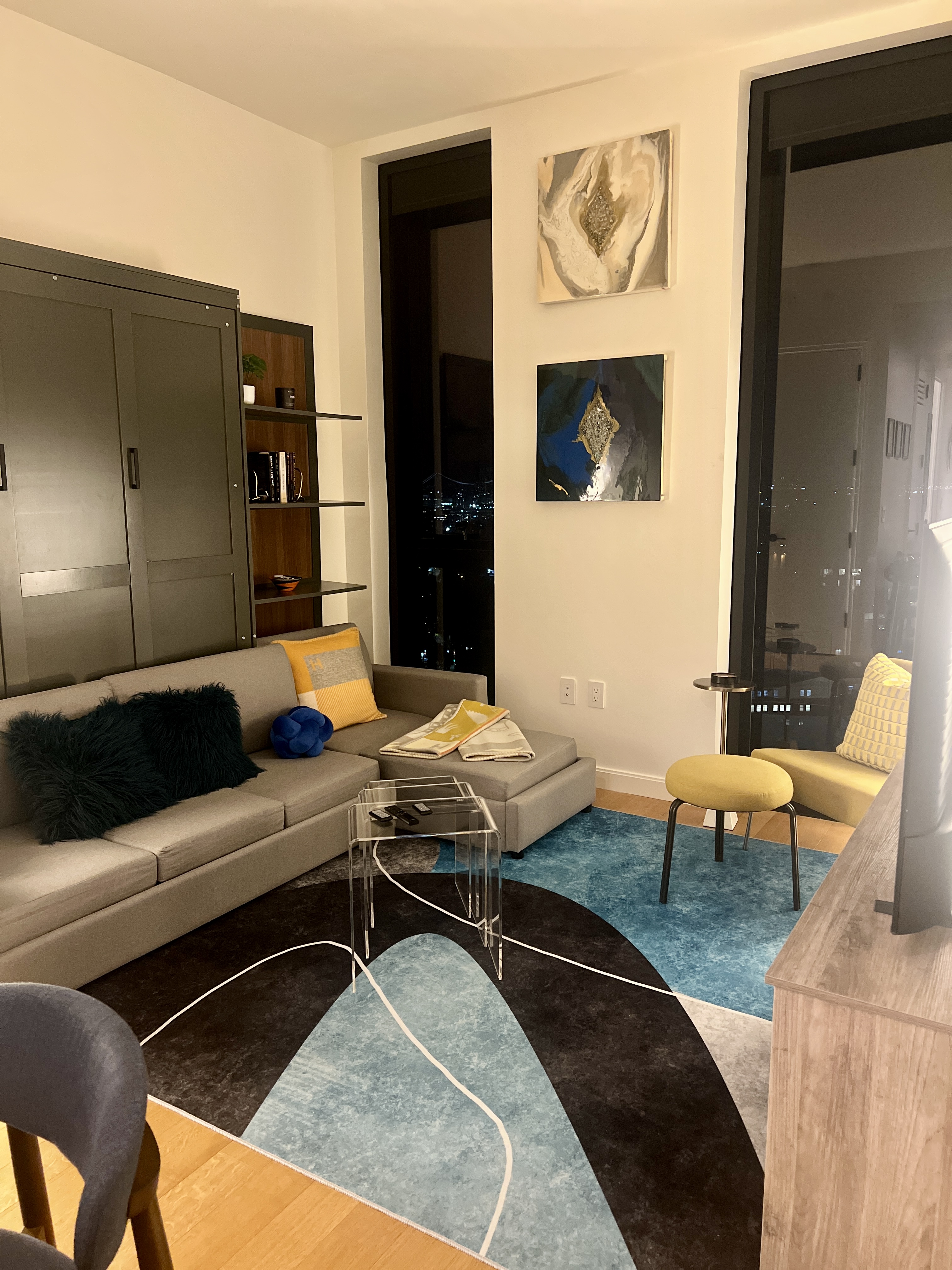 a living room with furniture pool table and painting on the wall