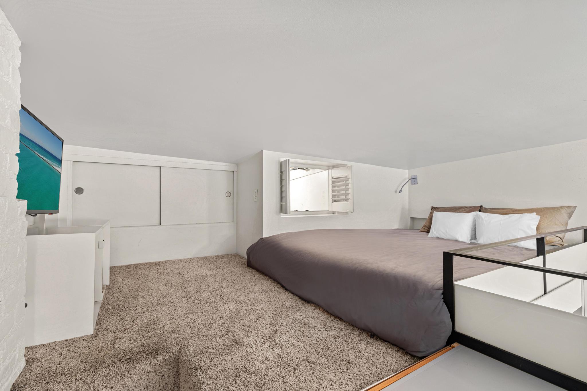 143 Sullivan Street, Unit 16 Manhattan, NY 10012 - Photo 7 of 10 a bedroom with a white bed and white walls