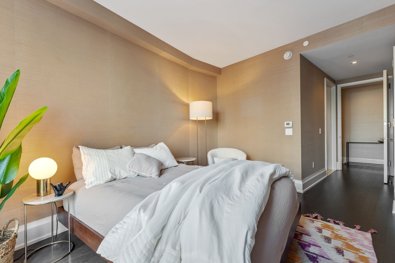 a bedroom with two beds and painting on the wall