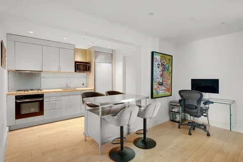 a kitchen with stainless steel appliances kitchen island granite countertop a sink and a stove