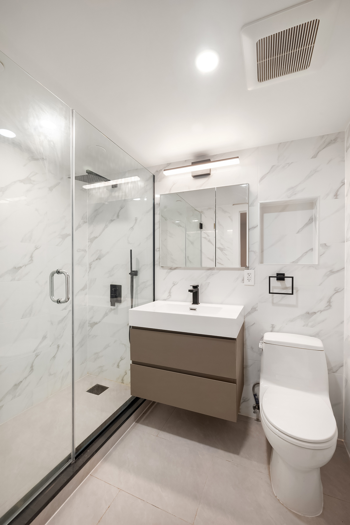 61 West 70th Street, Unit 1A Manhattan, NY 10023 - Photo 12 of 15 a bathroom with a sink mirror vanity and toilet