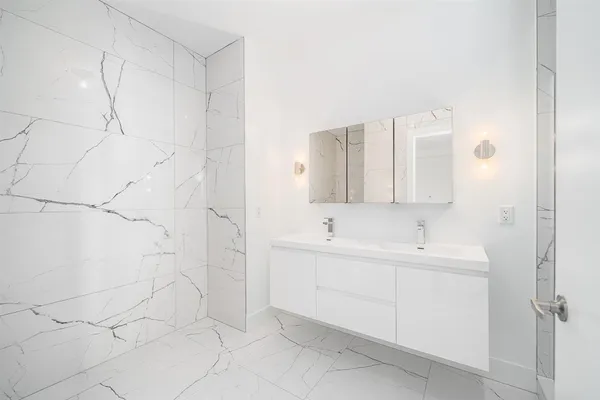 a bathroom with a sink and mirror