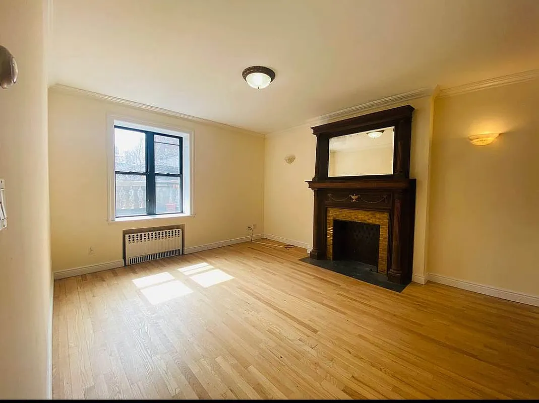 305 West 91st Street, Unit 4F Manhattan, NY 10024 - Photo 3 of 11 a view of empty room with wooden floor and fireplace