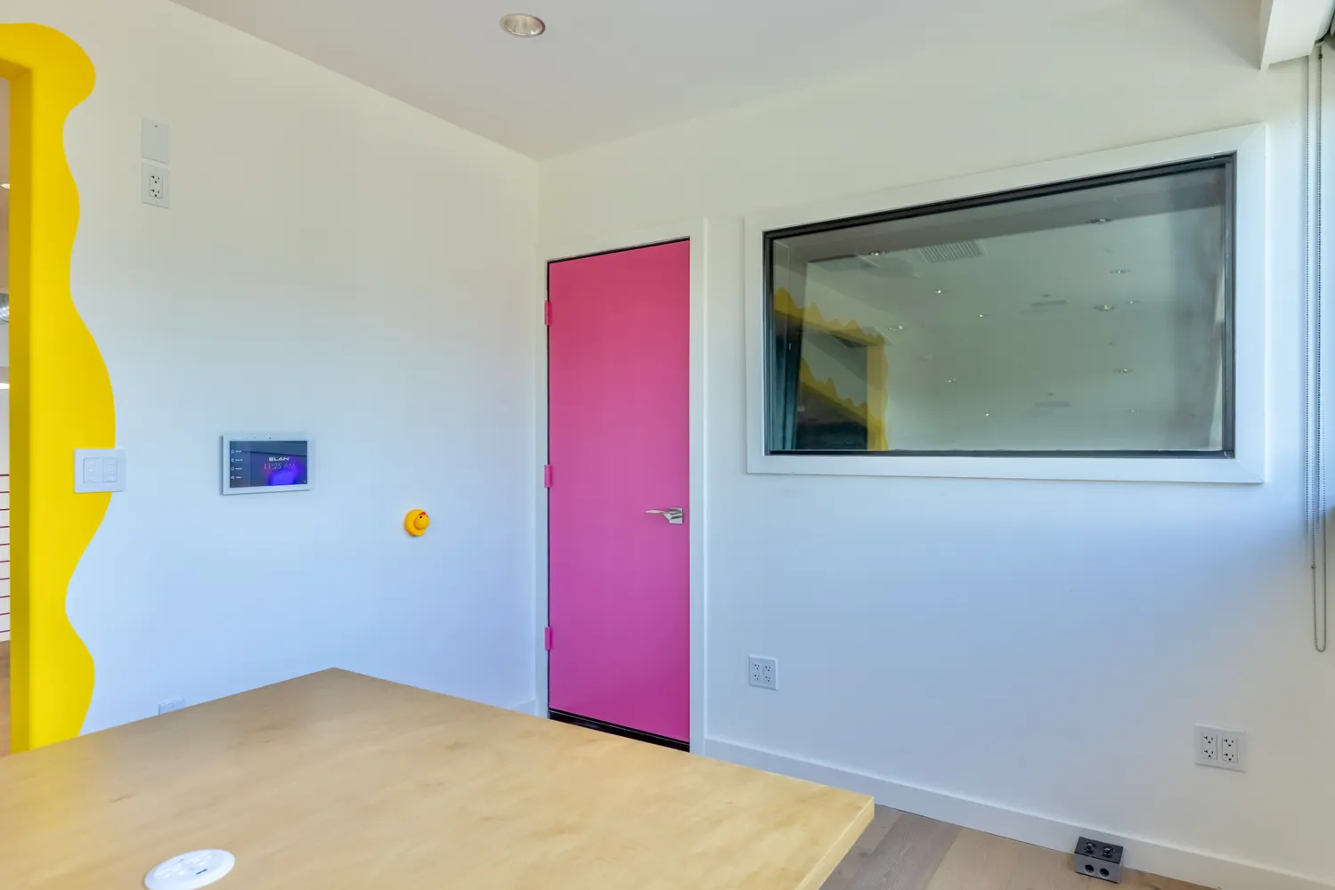 a view of a hallway with wooden floor and a chandelier