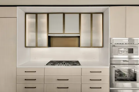 a kitchen with stainless steel appliances granite countertop a stove and a refrigerator