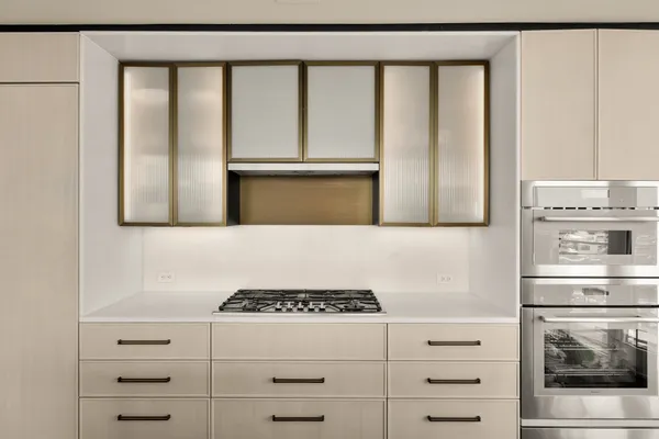 a kitchen with stainless steel appliances granite countertop a stove and a refrigerator