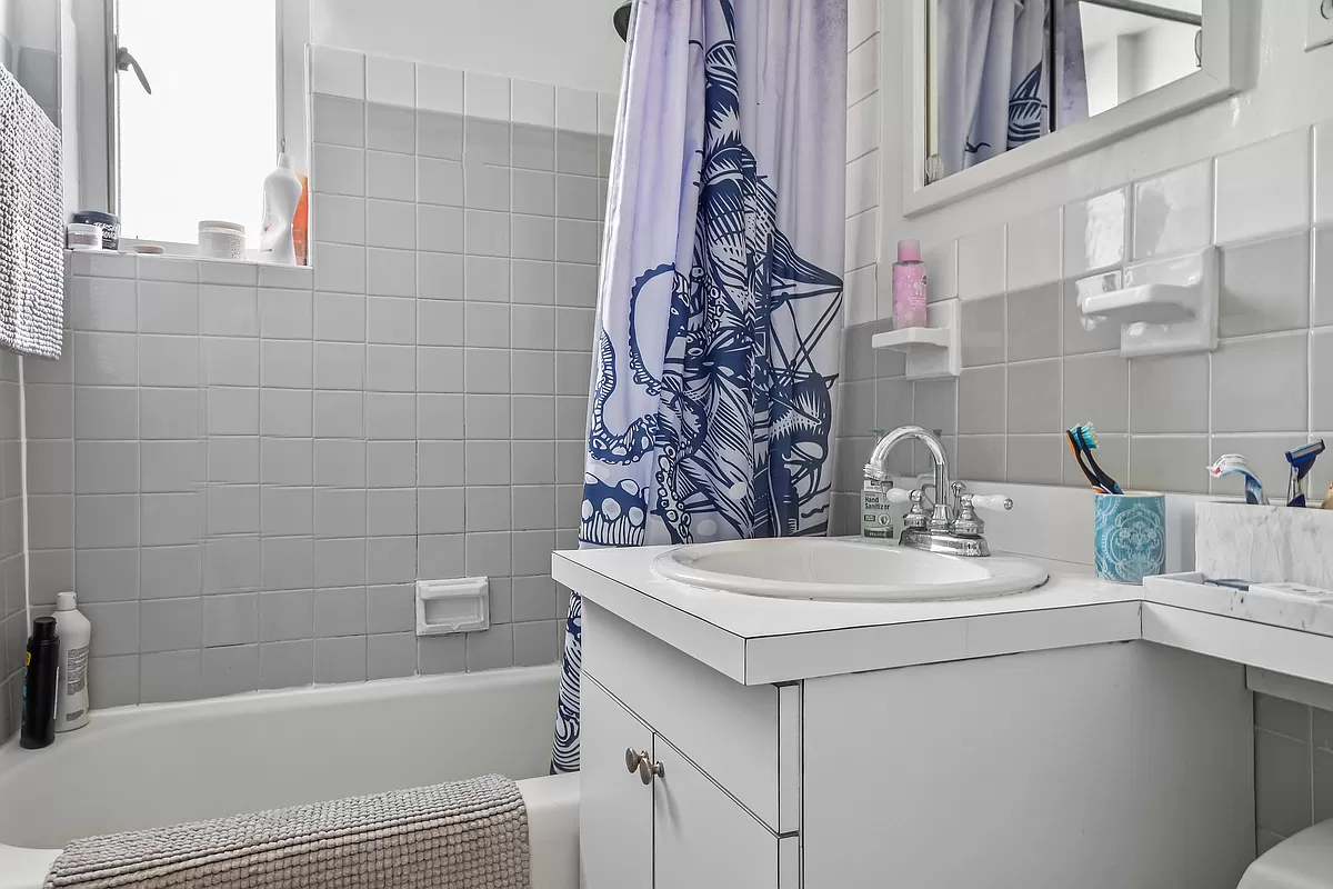 411 East 53rd Street, Unit 17A Manhattan, NY 10022 - Photo 7 of 10 a bathroom with a sink and a bathtub