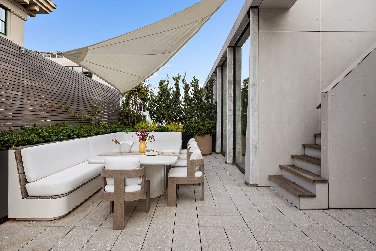 a balcony with table and chairs